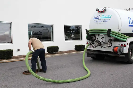 Ready Rooter technician connecting the pump hose at a commercial property