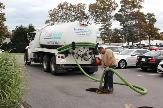 Septic truck and hose at a commercial building