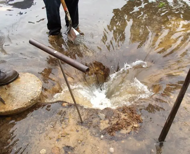 Water jet clearing a drain line