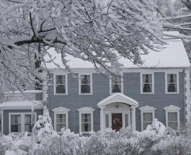 Snow-covered Cape Cod home in winter