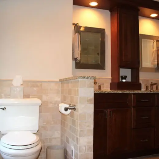 Bathroom with wood vanity and tiled mirror